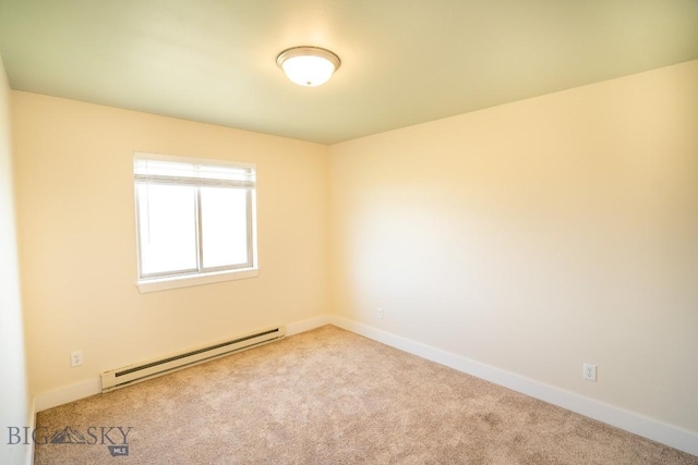 spare room with carpet, baseboards, and baseboard heating