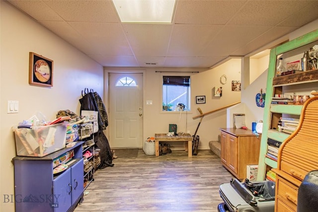 entrance foyer with wood-type flooring and a paneled ceiling