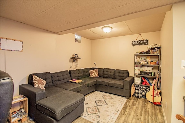 living room with hardwood / wood-style floors and a paneled ceiling