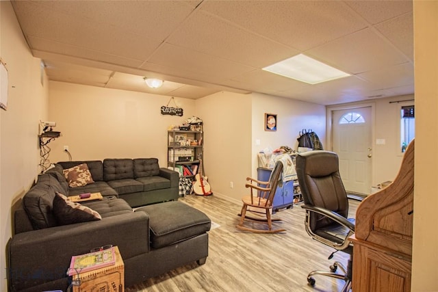 office with hardwood / wood-style floors and a paneled ceiling