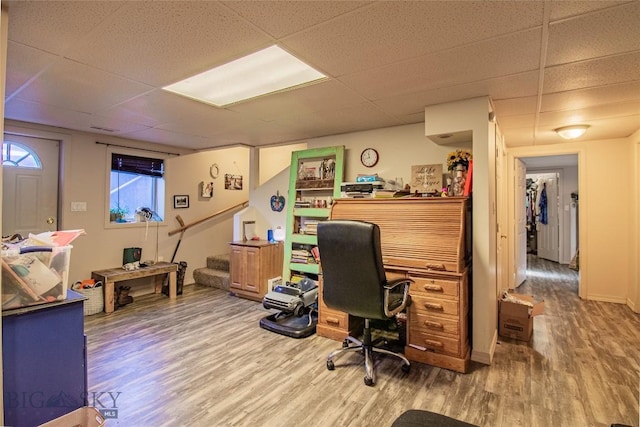 office space with hardwood / wood-style floors and a paneled ceiling