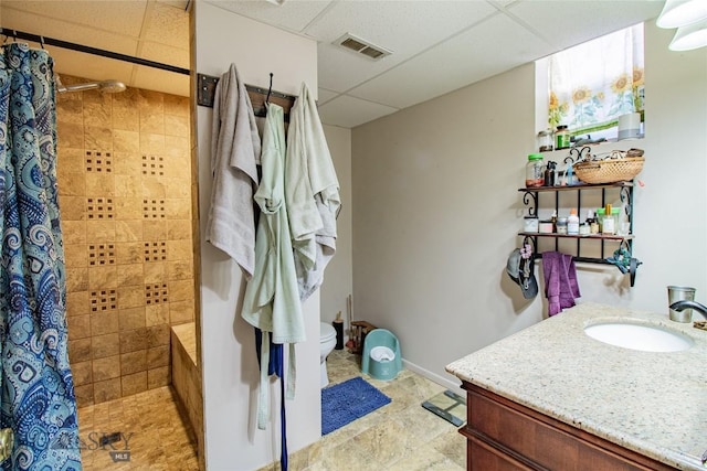 bathroom featuring vanity, toilet, a paneled ceiling, and a shower with curtain