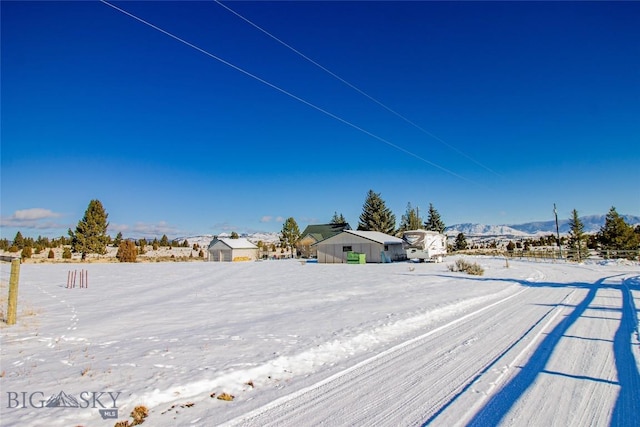 snowy yard with a mountain view