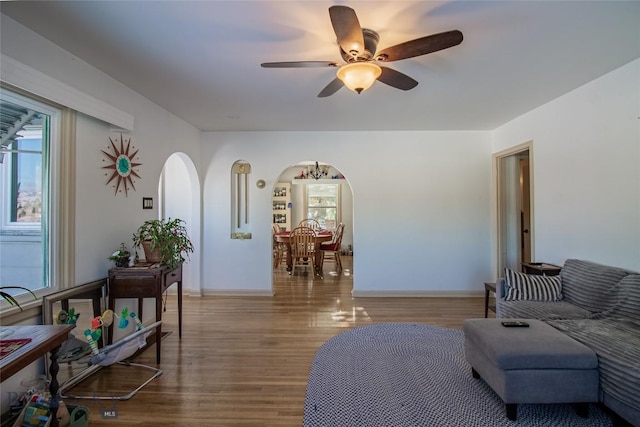 living room with wood-type flooring and ceiling fan