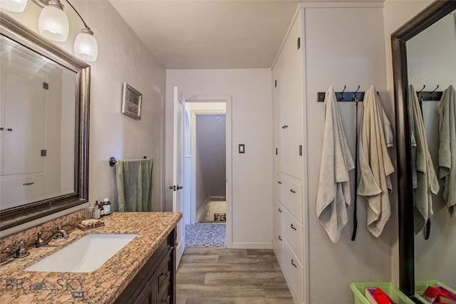 bathroom featuring vanity and hardwood / wood-style floors