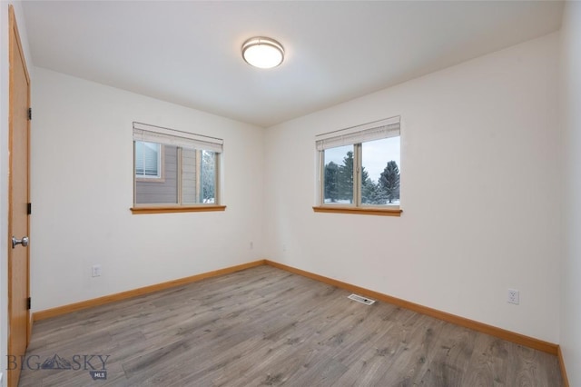 1121 Buckrake Ave, Bozeman, MT 59718 - spare room featuring plenty of natural light, baseboards, and wood finished floors