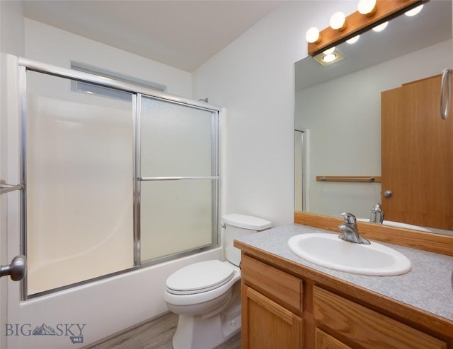 1121 Buckrake Ave, Bozeman, MT 59718 - full bathroom featuring toilet, vanity, bath / shower combo with glass door, and wood finished floors