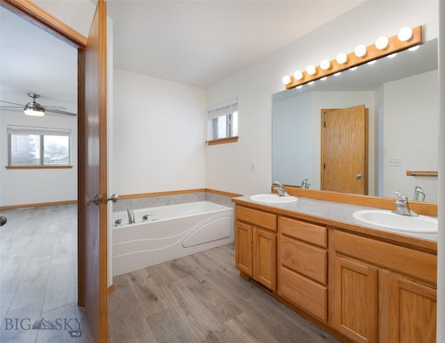 1121 Buckrake Ave, Bozeman, MT 59718 - bathroom with wood finished floors, ceiling fan, a bath, and double vanity