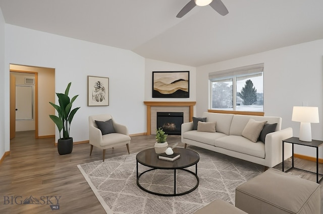 1121 Buckrake Ave, Bozeman, MT 59718 - living room with lofted ceiling, baseboards, wood finished floors, ceiling fan, and a lit fireplace