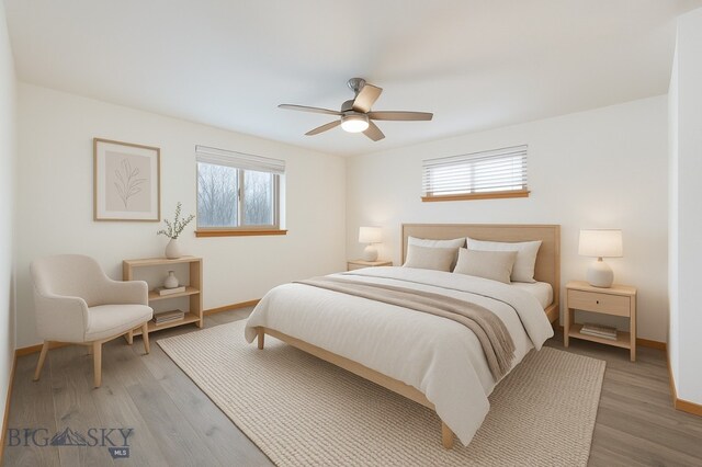 1121 Buckrake Ave, Bozeman, MT 59718 - bedroom with multiple windows, baseboards, and light wood-style floors