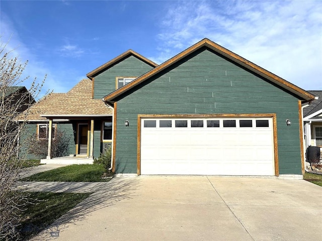 1121 Buckrake Ave, Bozeman, MT 59718 - view of front of home featuring an attached garage, concrete driveway, and roof with shingles