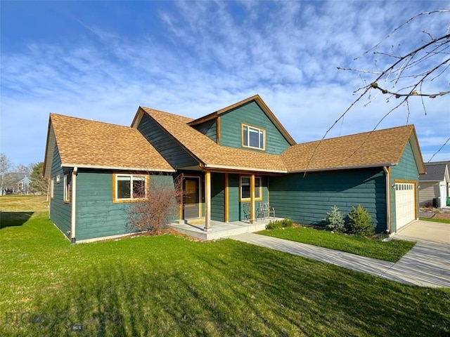 1121 Buckrake Ave, Bozeman, MT 59718 - view of front of property with a porch, a front lawn, concrete driveway, a garage, and a shingled roof
