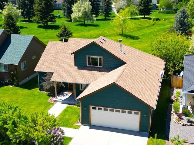 1121 Buckrake Ave, Bozeman, MT 59718 - view of front of property with a garage, concrete driveway, a front yard, and a shingled roof