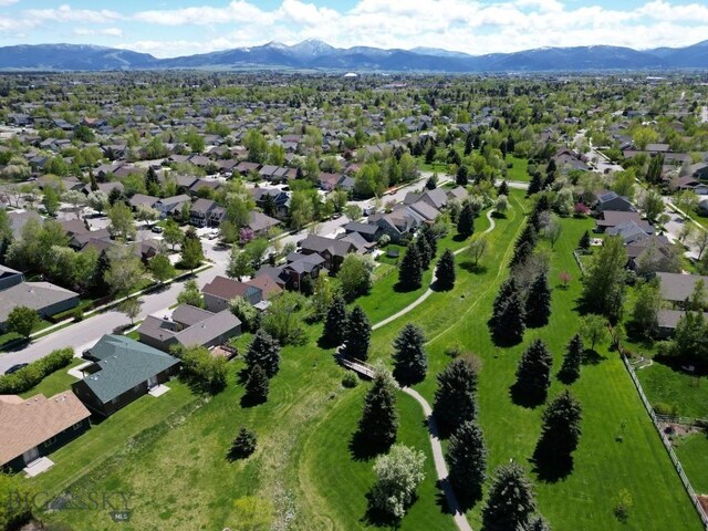1121 Buckrake Ave, Bozeman, MT 59718 - aerial view of property and surrounding area featuring a mountainous background and nearby suburban area