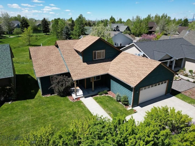1121 Buckrake Ave, Bozeman, MT 59718 - view of front of home with covered porch, roof with shingles, driveway, an attached garage, and a front yard