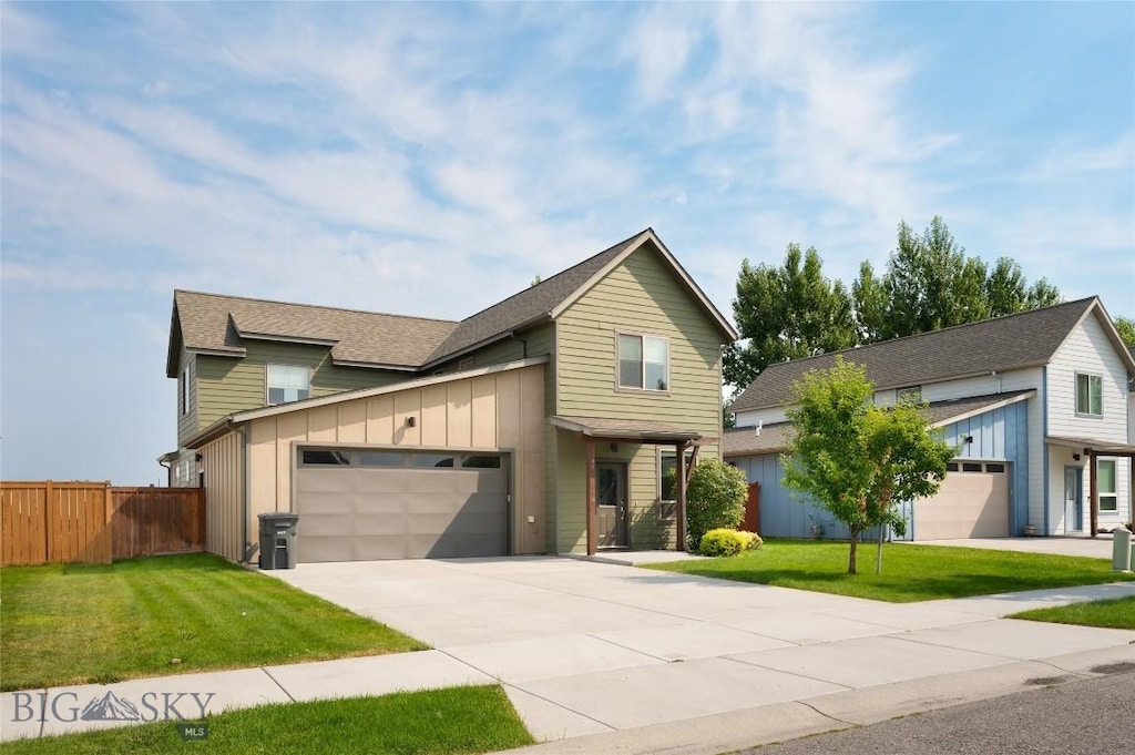 view of front of property with a garage and a front lawn