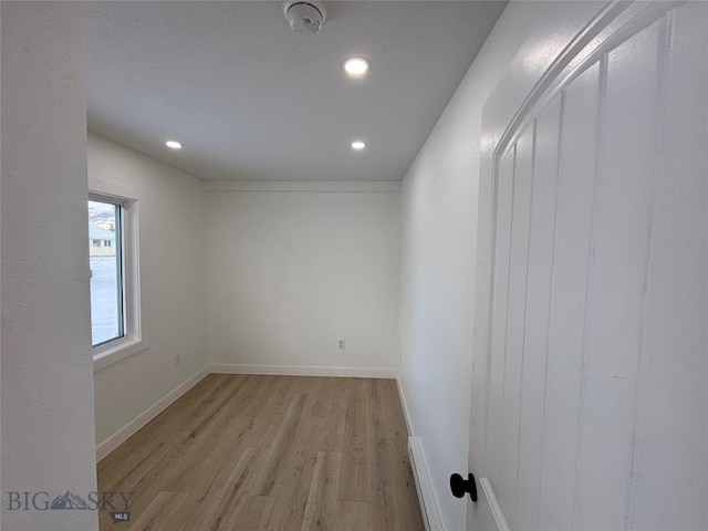 unfurnished room with light wood-type flooring