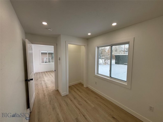 empty room with a healthy amount of sunlight and light hardwood / wood-style floors