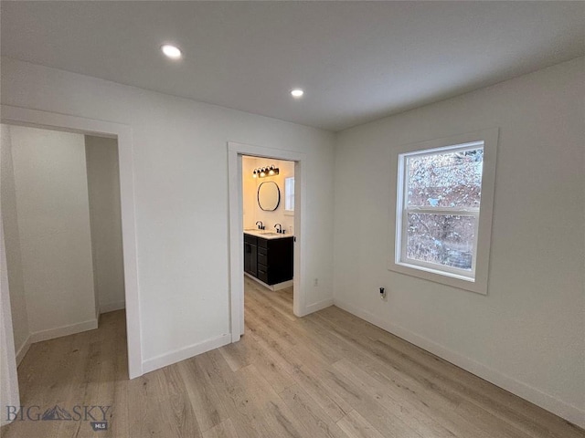 empty room with sink and light hardwood / wood-style flooring