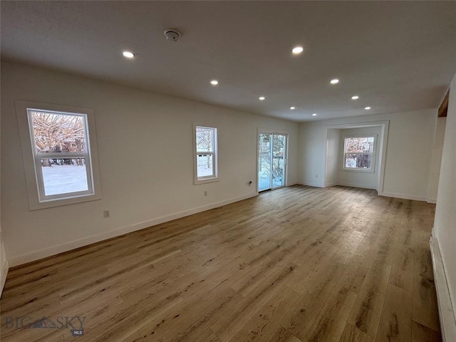 unfurnished room with light wood-type flooring