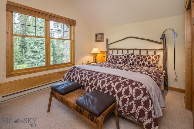 carpeted bedroom with lofted ceiling and a baseboard heating unit