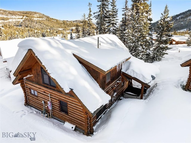 snowy aerial view with a mountain view