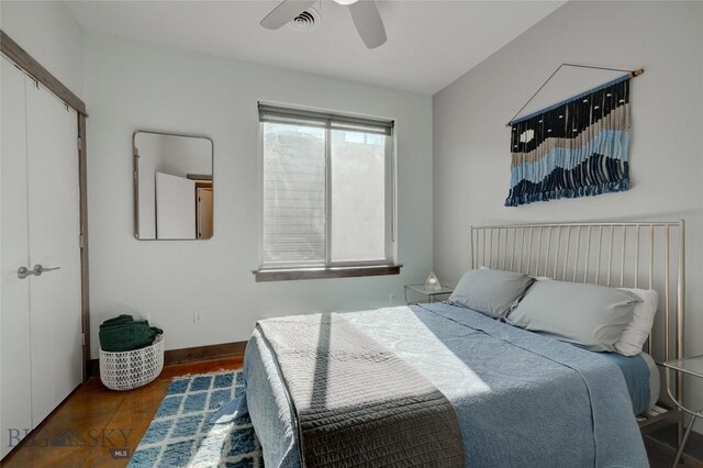 bedroom with ceiling fan, dark hardwood / wood-style flooring, and a closet