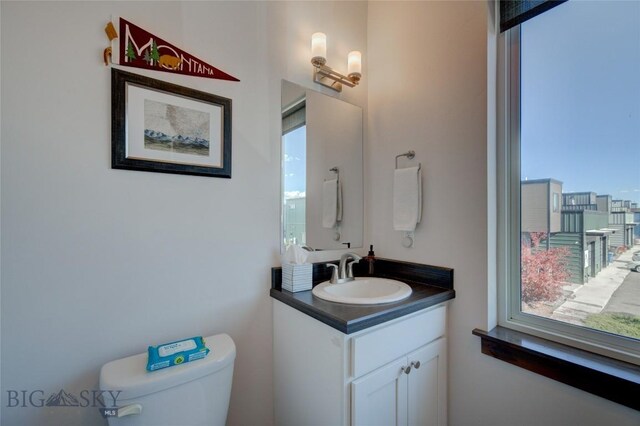 bathroom featuring vanity and toilet