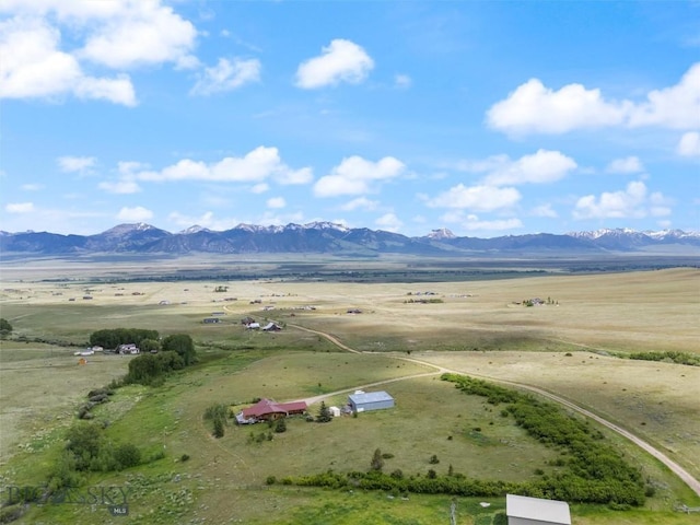 drone / aerial view featuring a mountain view and a rural view