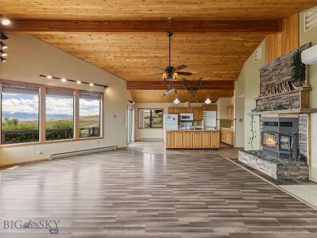 unfurnished living room with beam ceiling, high vaulted ceiling, and a baseboard heating unit