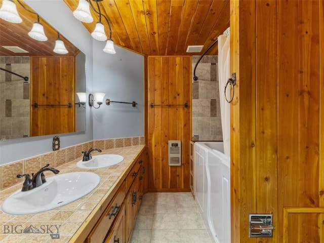 bathroom featuring shower / bathtub combination with curtain, vanity, wooden ceiling, and washing machine and clothes dryer