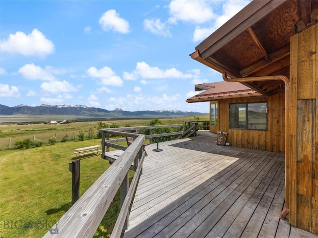 wooden deck featuring a mountain view, a yard, and a rural view