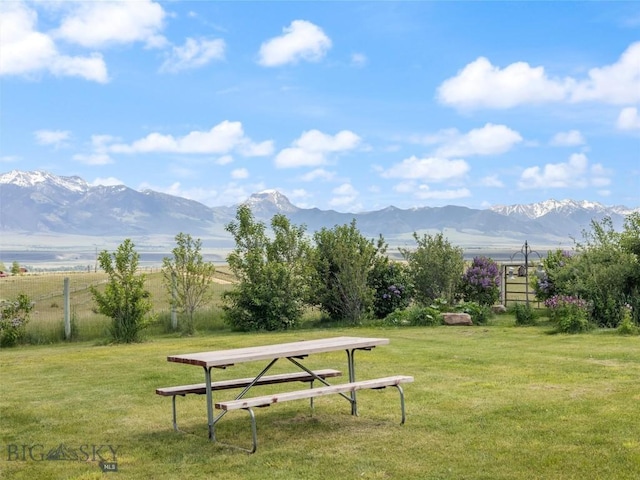 view of home's community featuring a mountain view, a yard, and a rural view