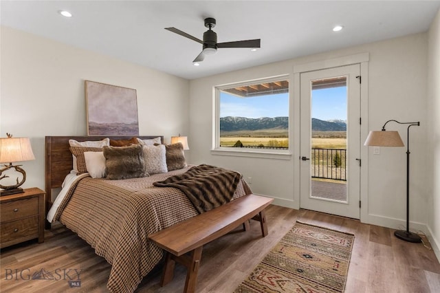 420 Sage Ave Unit B, Ennis, MT 59729 - bedroom with multiple windows, wood finished floors, access to exterior, and recessed lighting