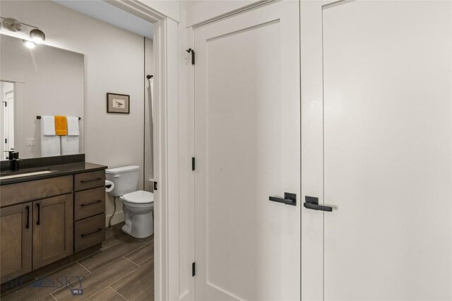 420 Sage Ave Unit B, Ennis, MT 59729 - bathroom featuring wood tiled floor, vanity, and toilet