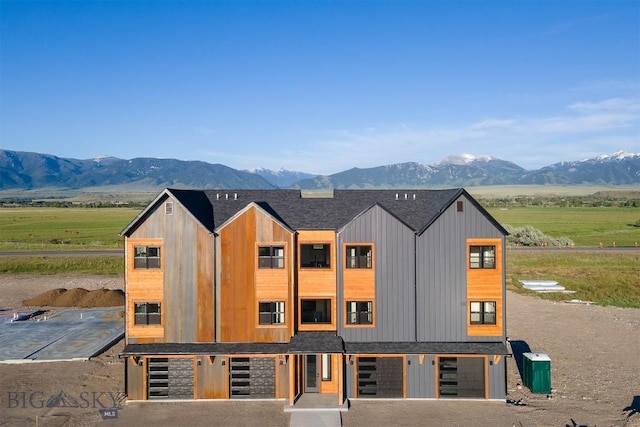 view of front of home with a mountain view and a garage