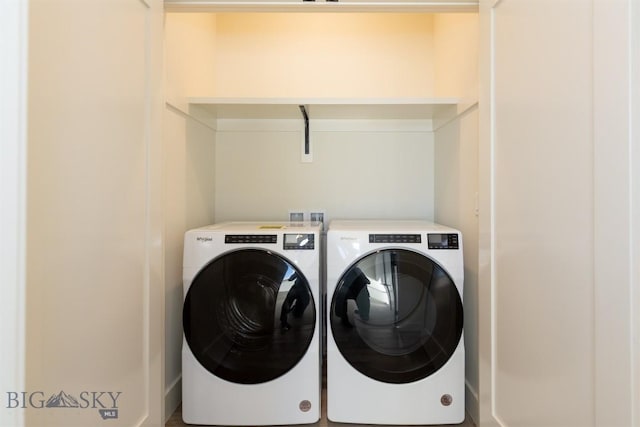 clothes washing area with washing machine and clothes dryer