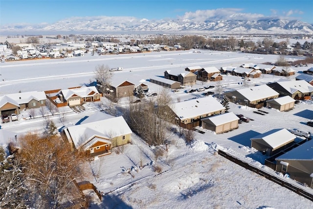 snowy aerial view featuring a mountain view