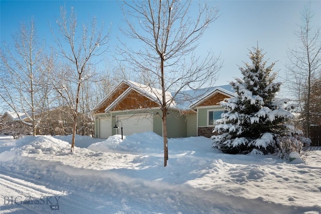 view of snow covered exterior featuring a garage