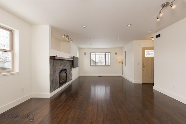 unfurnished living room with dark hardwood / wood-style flooring and a fireplace