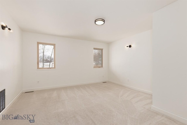 unfurnished room featuring light colored carpet