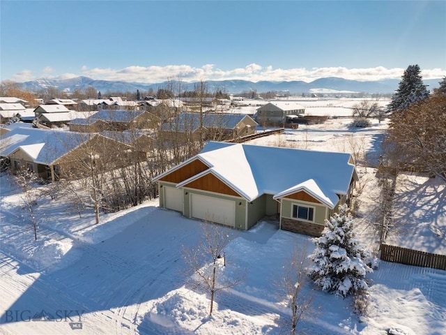 snowy aerial view featuring a mountain view