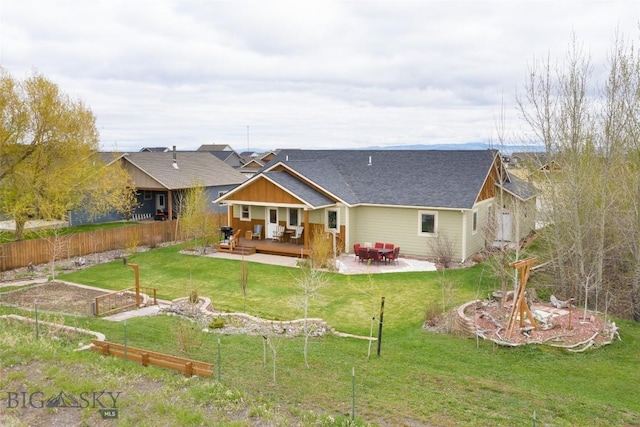 back of house with a lawn and a wooden deck