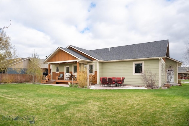 back of house with a yard, a patio, and a wooden deck