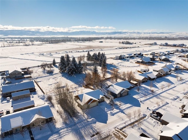 snowy aerial view with a mountain view