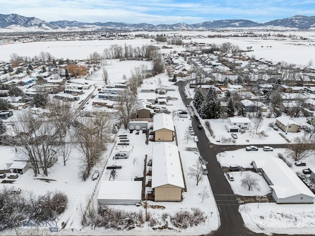 snowy aerial view featuring a mountain view