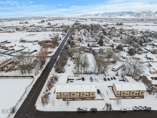 snowy aerial view featuring a mountain view