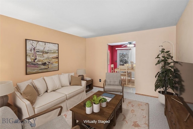 carpeted living room with ceiling fan