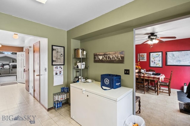 interior space with refrigerator and ceiling fan