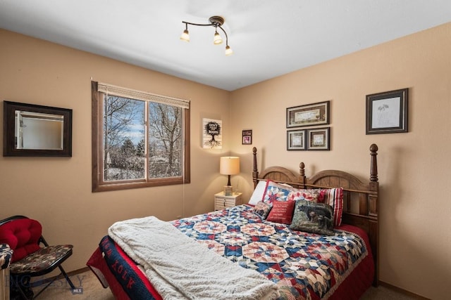 carpeted bedroom featuring track lighting